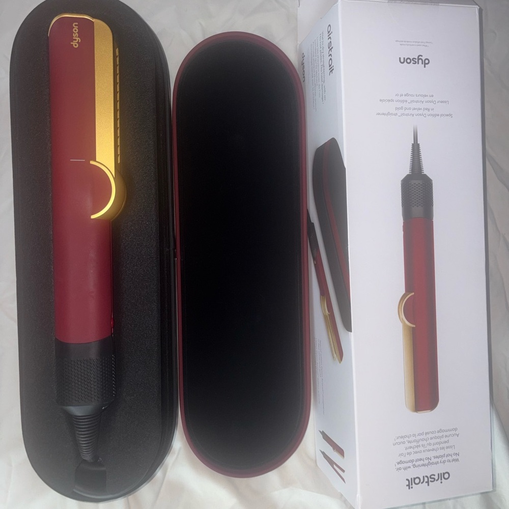 Dyson red and gold Airwrap-style hot tool with matching case